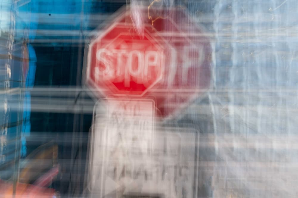 A blurry stop sign indicating impaired vision, representing the dangers of drug-impaired driving.